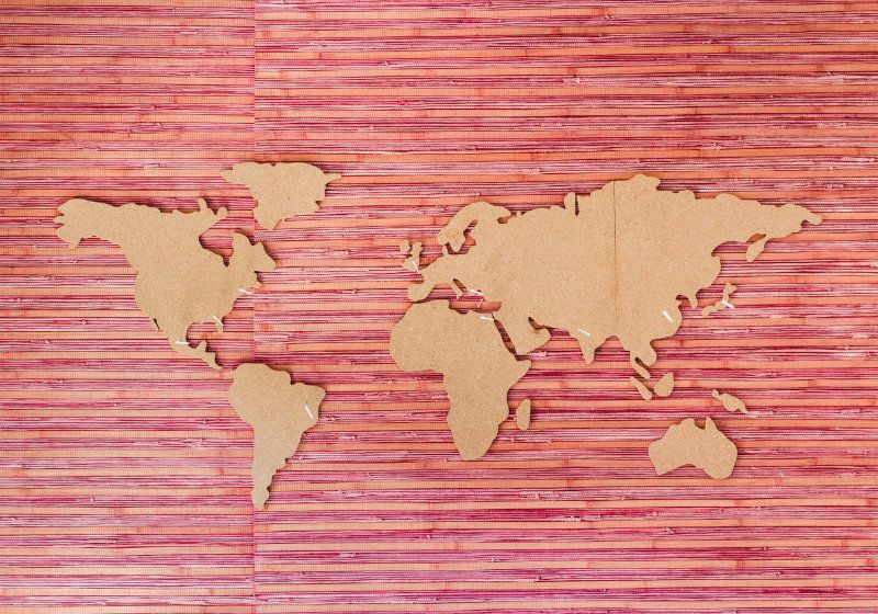 map of the world on a pink striped background
