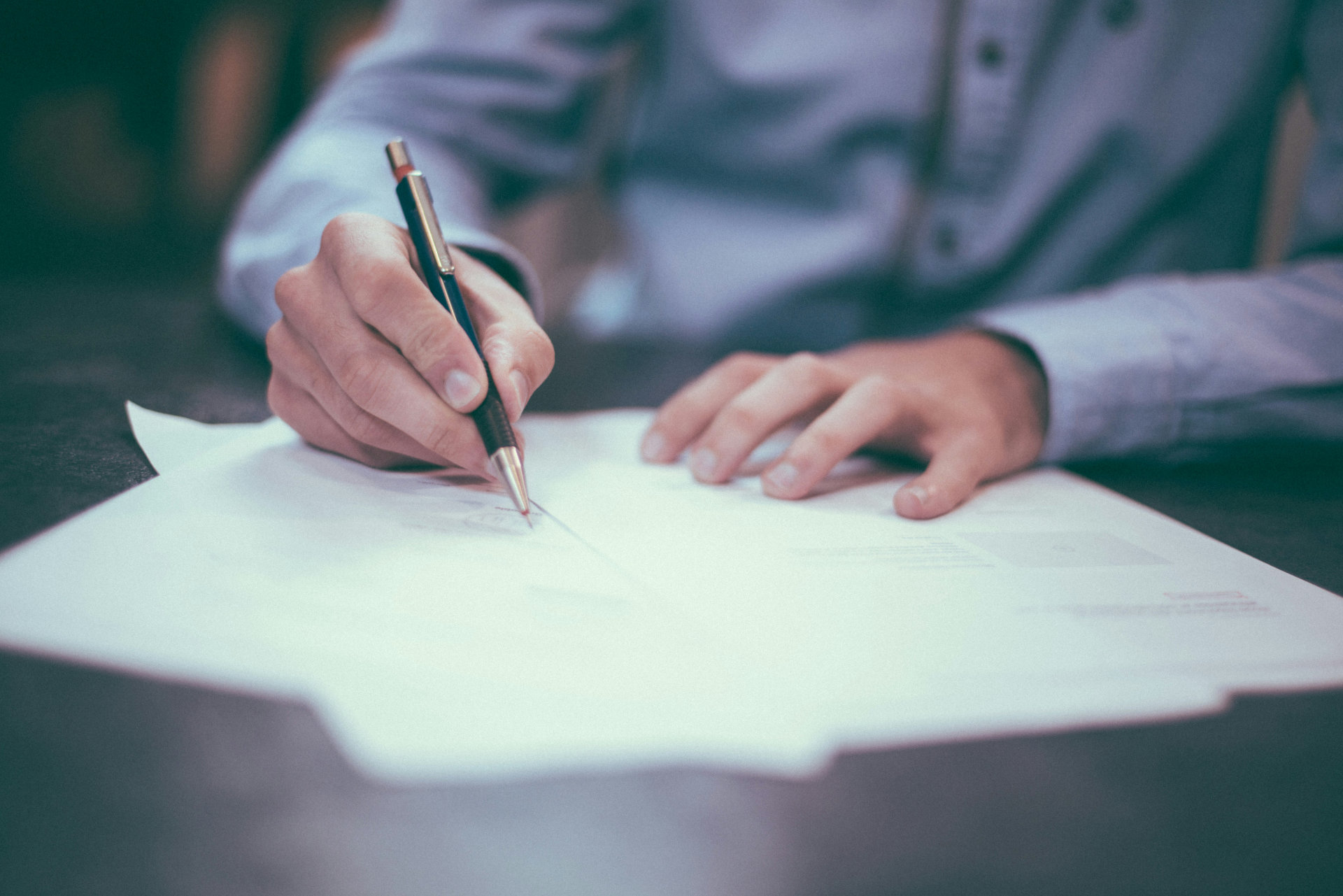 Person writing on papers.